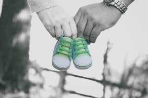 Casal a segurar e par de sapatos de bebé