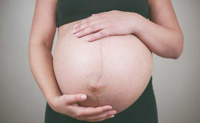 Barriga de grávida com uma linha negra